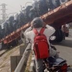 Trolley Loaded with Tractors Crashes Through Bridge Railing and Hangs Suspended in Mid-Air
