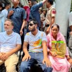 Rahul Gandhi sits on a protest outside the Parliament Street police station