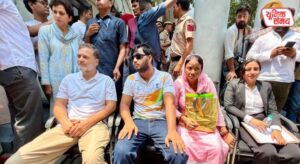 Rahul Gandhi sits on a protest outside the Parliament Street police station